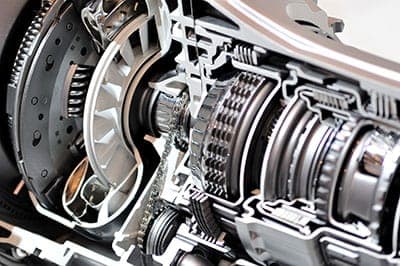 Mechanic inspecting a vehicle clutch and transmission in Jacksonville, FL