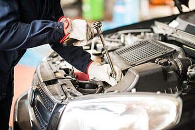 Mobile mechanic repairing a vehicle radiator and cooling system in Jacksonville, FL